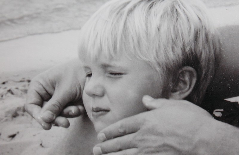 Shawnelle's son, Grant, as a young boy, being caressed by his father.