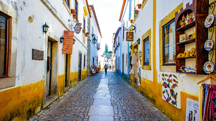 In Obidos, whitewashed houses are held in by medieval city walls.