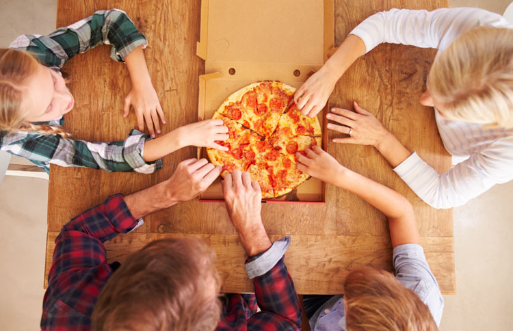 Every member of the family reaches for a slice of pizza