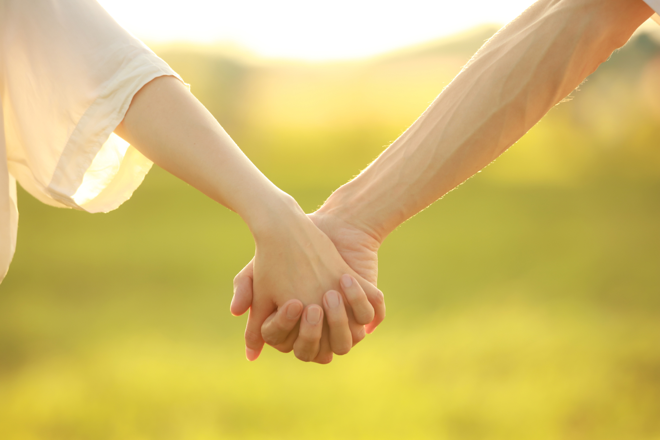 Two people holding hands; Getty Images