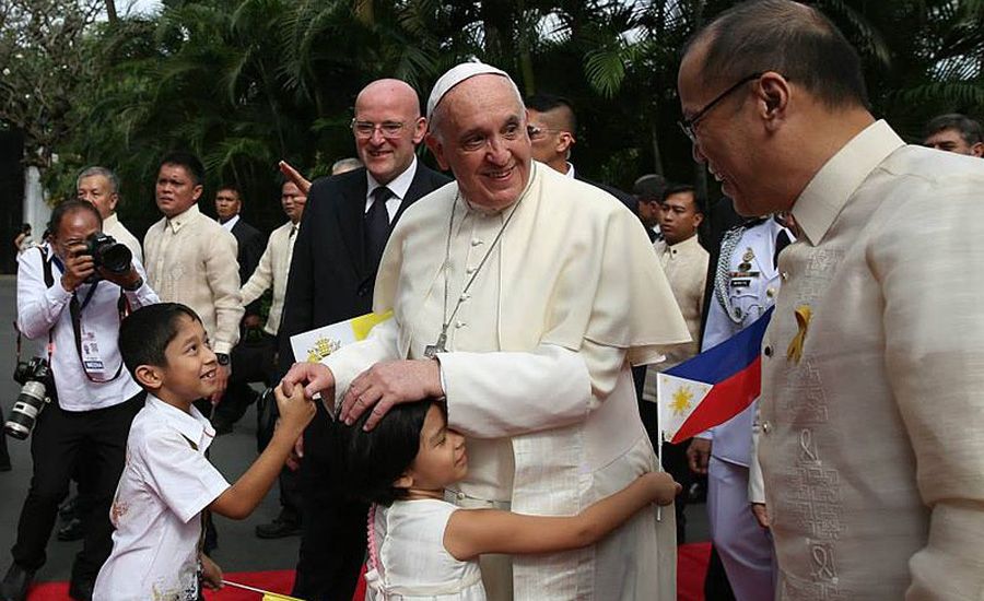 His Holiness Pope Francis, accompanied by President Benigno S. Aquino III, hugs children at the garden area of the Malacañan Palace during the welcome ceremony for the State Visit and Apostolic Journey to the Republic of the Philippines on Friday (January 16, 2015)