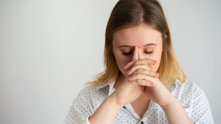 A woman in write saying prayers for fasting