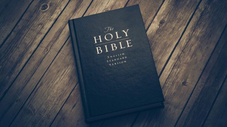 A Bible rests on a wooden table