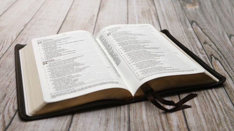 An open bible on a wooden table