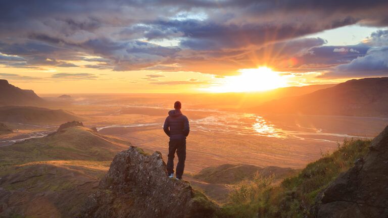 Hiker on a mountain at sunrise