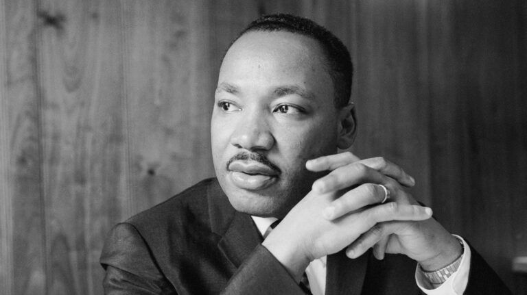 Martin Luther King Jr. listening at a meeting of the SCLC staff at an Atlanta restaurant