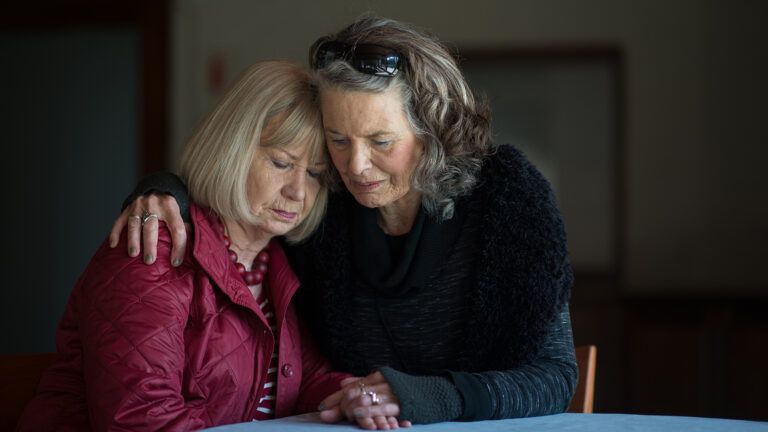 A woman comforts her friend