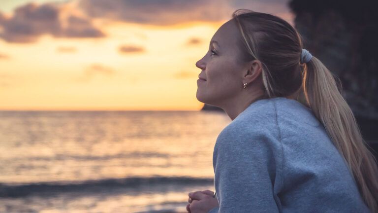 Woman enjoying the sunset at the beach